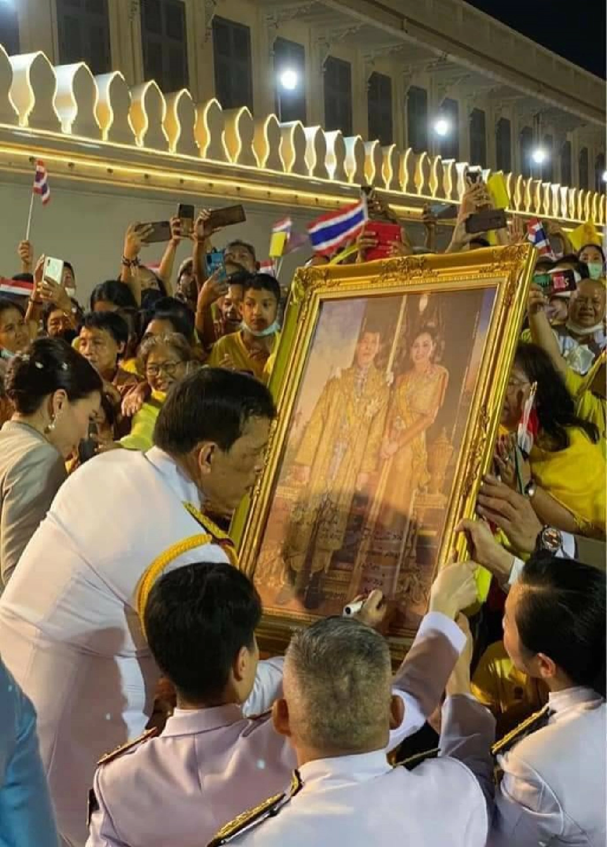 ในหลวงทรงพระอักษรบนพระบรมฉายาลักษณ์ของประชาชนที่เฝ้ารับเสด็จ